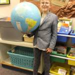Staff photo/Heather Spaulding                                Henry Jensen holds a globe.