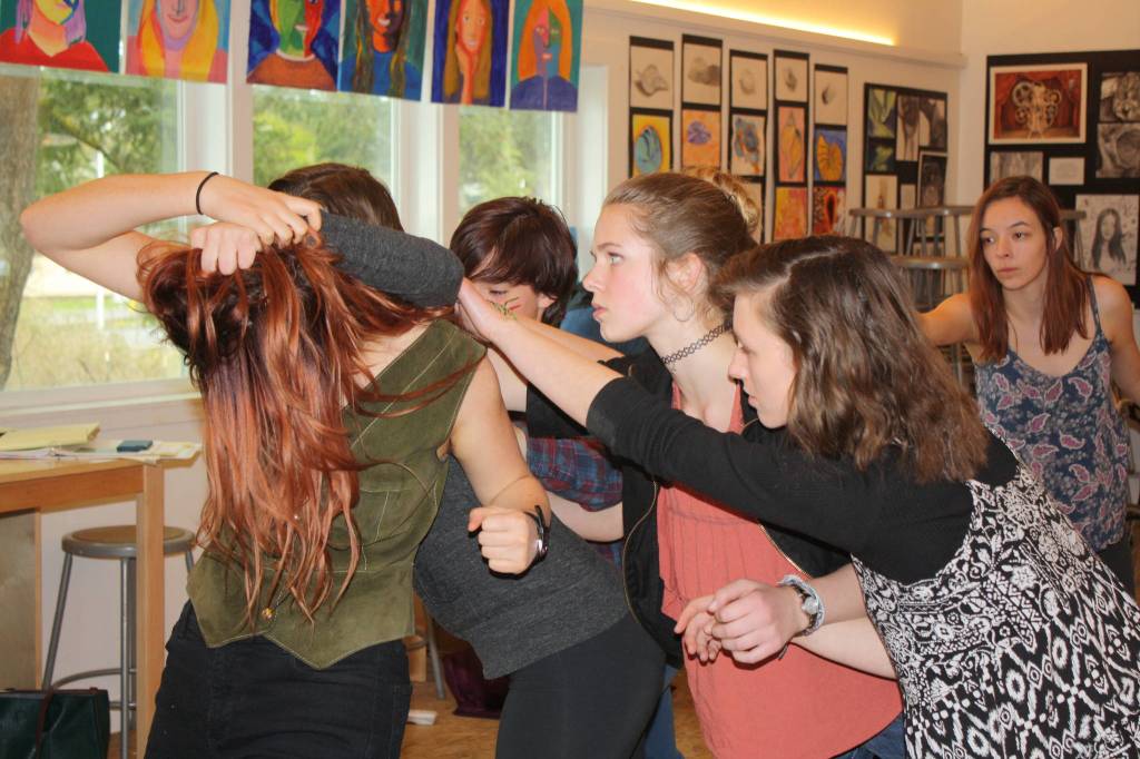 Staff photo/Hayley Day                                Junior Ula Grace said she plays the whistleblower, who is attacked by fellow classmates in this scene.