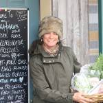 Staff photo/Hayley Day                                Lori Ann David, owner of Aurora Farms, holds items in this months CSA items in front of the farms food store.