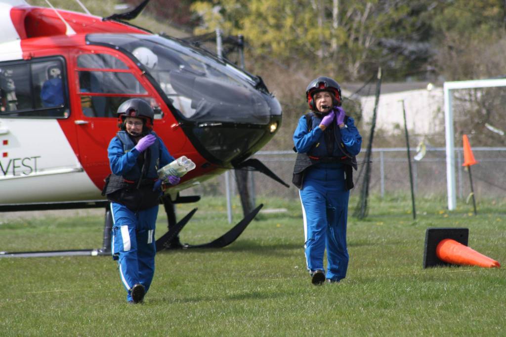 Staff photo/Hayley Day                                A helicopter lands on the high school field to deploy the medevac crew.