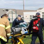 Staff photo/Hayley Day                                Members of local rescue crews attend to the student actors during the program.