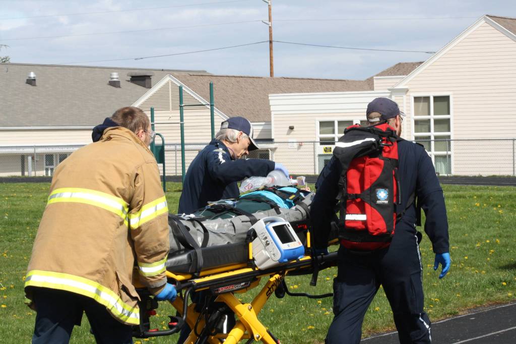 Staff photo/Hayley Day                                Members of local rescue crews attend to the student actors during the program.