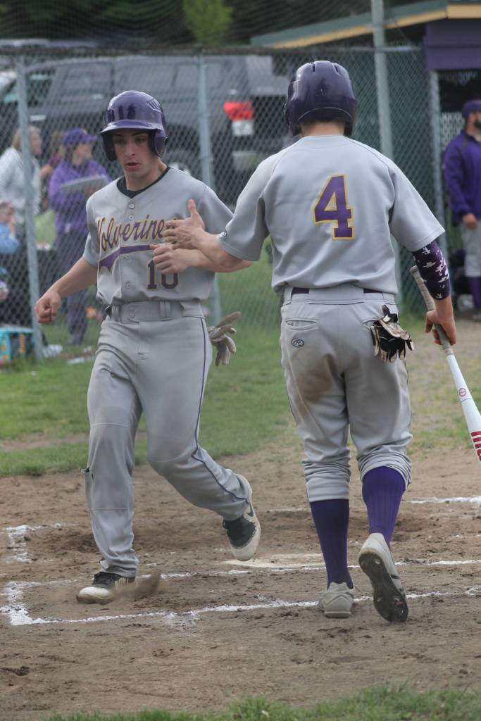 Staff photo/Heather Spaulding. Wolverine Nick Herko congratulates teammate Jaden Jones after they both make it home.