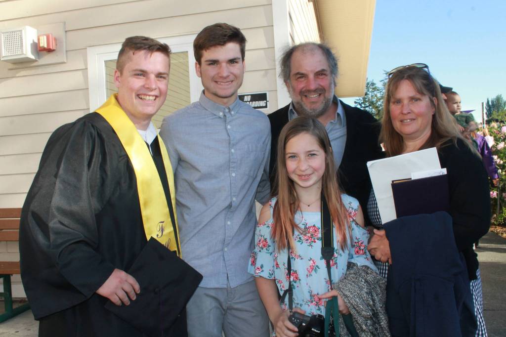 Staff photo/Heather Spaulding. Graduate Jackson Pieples with his family after the ceremony.