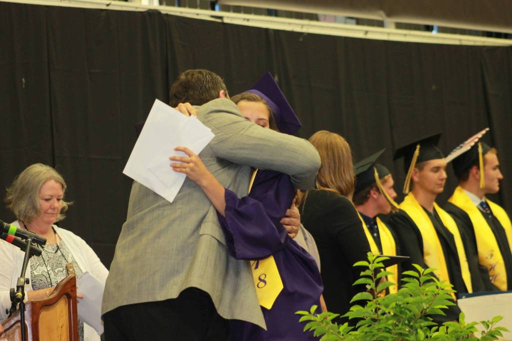 Staff photo/Heather Spaulding. Principal Fred Woods hugs daughter Kiana Woods.