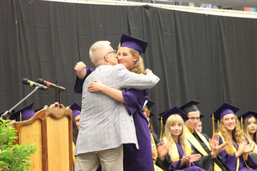 Staff photo/Heather Spaulding. Cart Nelsen hugs his daughter Tenly.