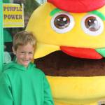 Staff photo/Hayley Day                                A child poses with the Vics burger mascot outside the 60th-anniversary party.
