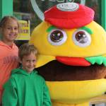Staff photo/Hayley Day                                Kids pose with the Vics burger mascot outside the 60th-anniversary party.