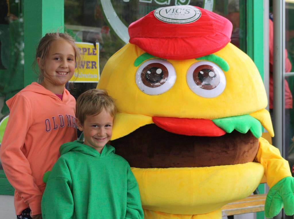 Staff photo/Hayley Day                                Kids pose with the Vics burger mascot outside the 60th-anniversary party.