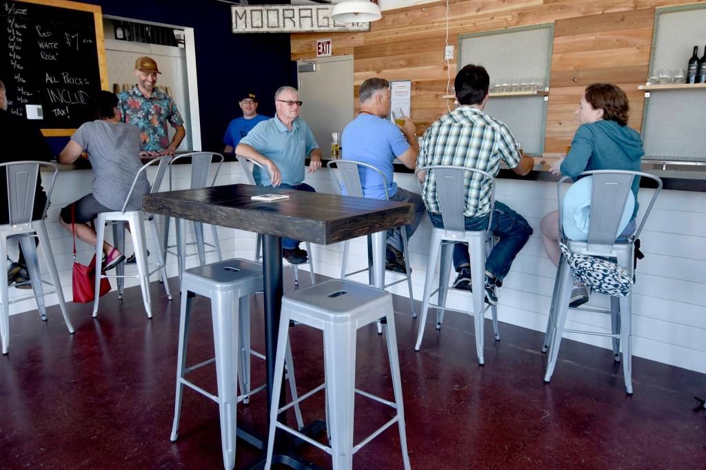 Staff photo/Tate Thomson                                Patrons enjoy the new bar at its soft opening on July 26.