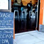 Staff photo/Tate Thomson                                Patrons enjoy the new bar at its soft opening on July 26.