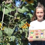 Staff photo/Hayley Day                                Meg Strehlou shows off a box of finished, recycled crayons outside her San Juan Island home.