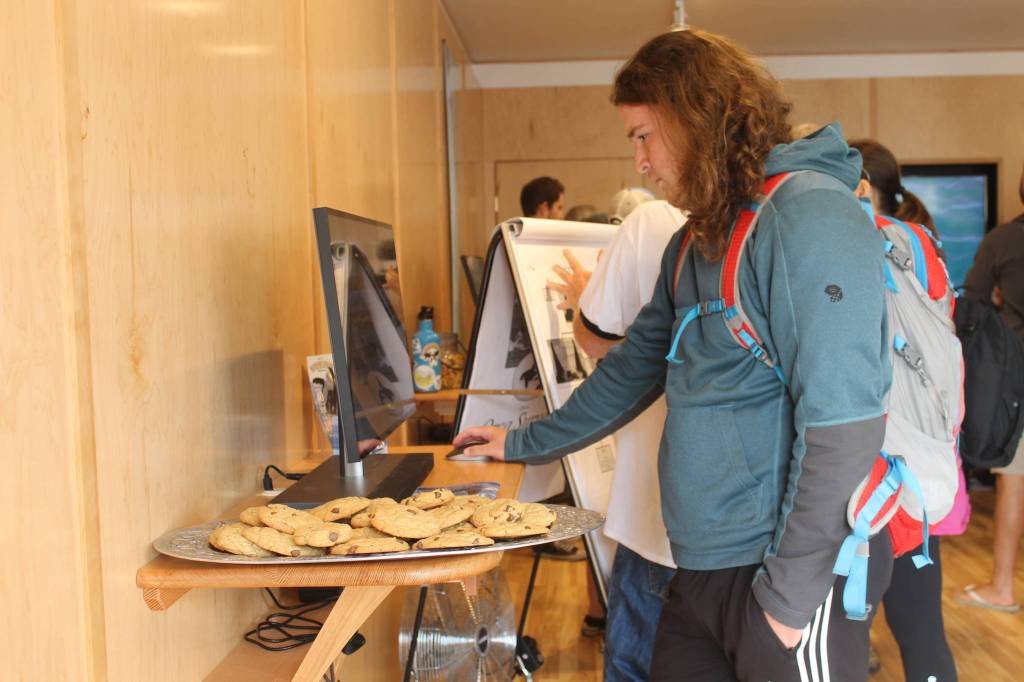 Staff photo/Heather Spaulding. A visitor tries out the centers interactive computers.