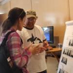 Staff photo/Heather Spaulding. Dave Ellifrit, photo ID specialist talks with a visitor about Orca IDing.