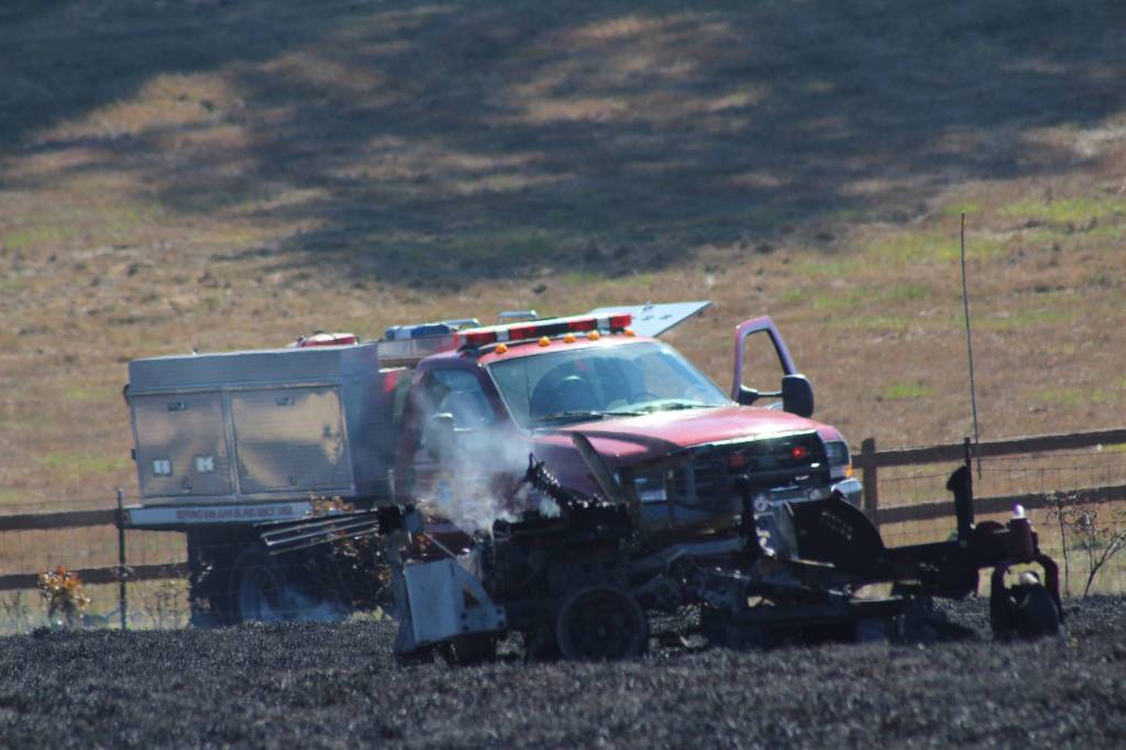 Staff photo/Hayley Day                                A smoldering piece of farm equipment remains.