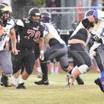 Contributed photo/John Stimpson                                Emeron Geiser runs for extra yardage, while Milo Geiser helps clear the way.