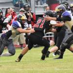 Contributed photo/John Stimpson                                Wolverines Brian Wolf and Kyson Jackson bring down Wolves running back for lost yardage.