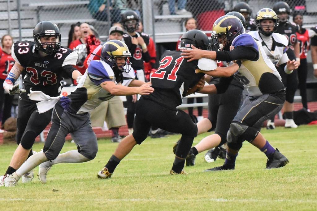 Contributed photo/John Stimpson                                Wolverines Brian Wolf and Kyson Jackson bring down Wolves running back for lost yardage.