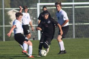 Staff photo/Heather Spaulding. Nick Herko steals the ball from La Conner.