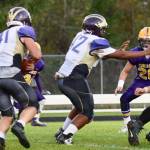 Contributed photo / John K. Stimpson                                Wolverine Emeron Geiser, 41, makes for an opening as Matro Blackmon, 42, blocks the Lions defense.