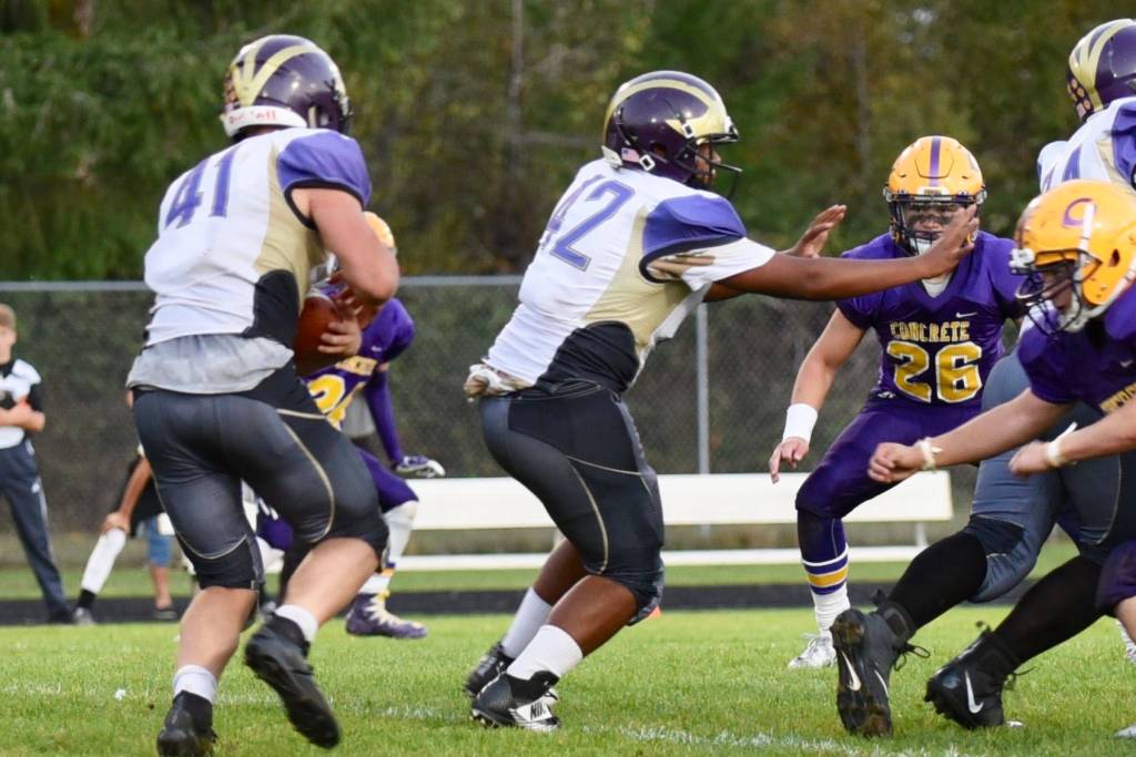 Contributed photo / John K. Stimpson                                Wolverine Emeron Geiser, 41, makes for an opening as Matro Blackmon, 42, blocks the Lions defense.