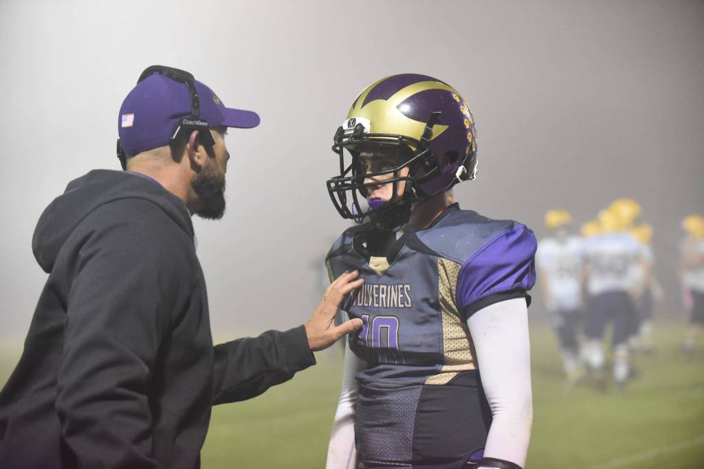 Contributed photo/John Stimpson                                Head coach Brock Hauck gives quarterback Jaden Jones the next plays to run.