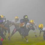 Contributed photo/John Stimpson                                With the fog as thick as pea soup, Kaden Ritchie runs for yardage.