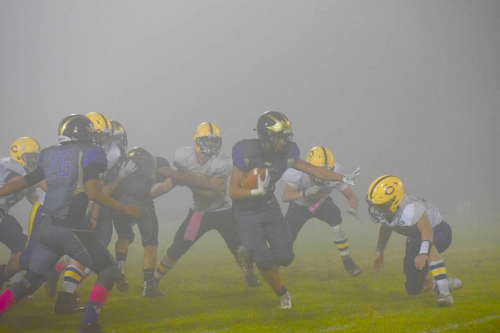 Contributed photo/John Stimpson                                With the fog as thick as pea soup, Kaden Ritchie runs for yardage.