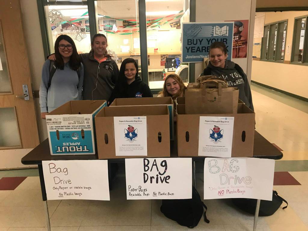 Contributed photo                                Emily Cain created a new service club at the school. Here the club is helping out another organization that packs bags of food for elementary school students over the weekend.