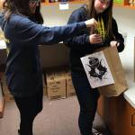 Contributed photo                                Emily Cain created a new service club at the school. Here the club is helping out another organization that packs bags of food for elementary school students over the weekend.