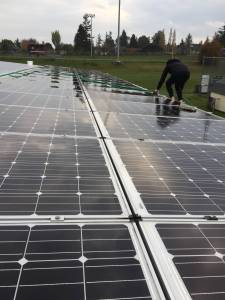 Contributed photo                                Rachel and Molly cleaned the STEM buildings solar panels as part of their community project.