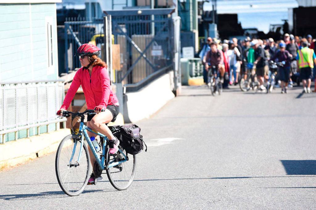 Staff photo/Tate Thomson Cyclists disembark on the ferry to San Juan Island.
