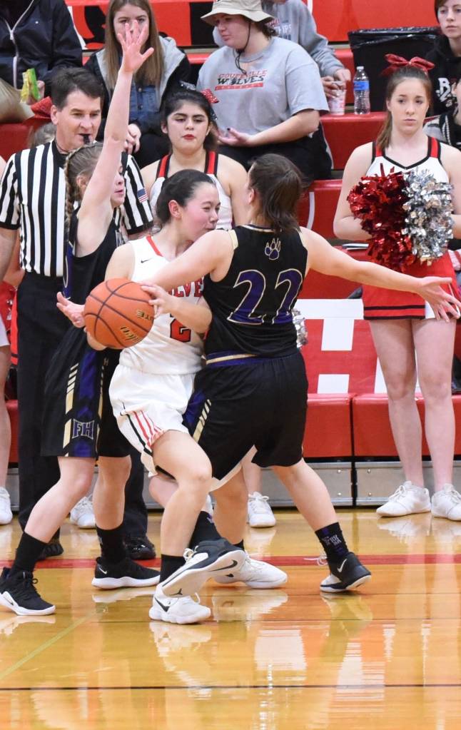 Contributed photo/John Stimpson                                Lady Wolverines box in the Wolves causing a turnover.