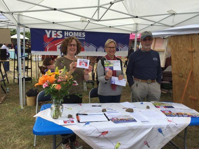 Submitted by YES for Homes campaign                                Penny Sharp Sky, Sheila Gaquin and Howard Barbour encourage voters to pass the REET at the farmers market on Orcas Island.