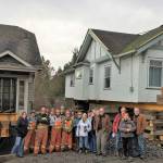 Contributed photo/San Juan Community Home Trust                                The Nickel Brothers crew and onlookers stand in front of the new home trust houses.