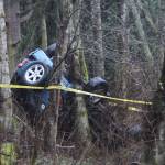 Staff photo/Hayley Day                                A Jeep lies upside down on the side of the road.
