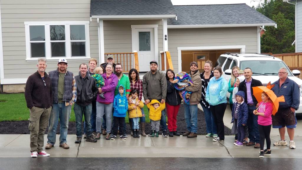 Contributed photo/Homes For Islanders                                Volunteers and homeowners celebrate Homes For Islanders most recent built at the end of Malcolm Street on Oct. 7.