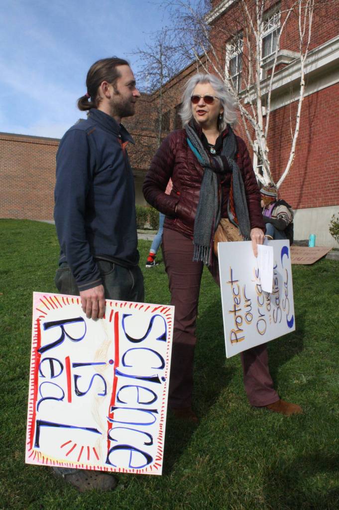 Staff photo/Heather Spaulding. A couple of marchers socialize after the event.