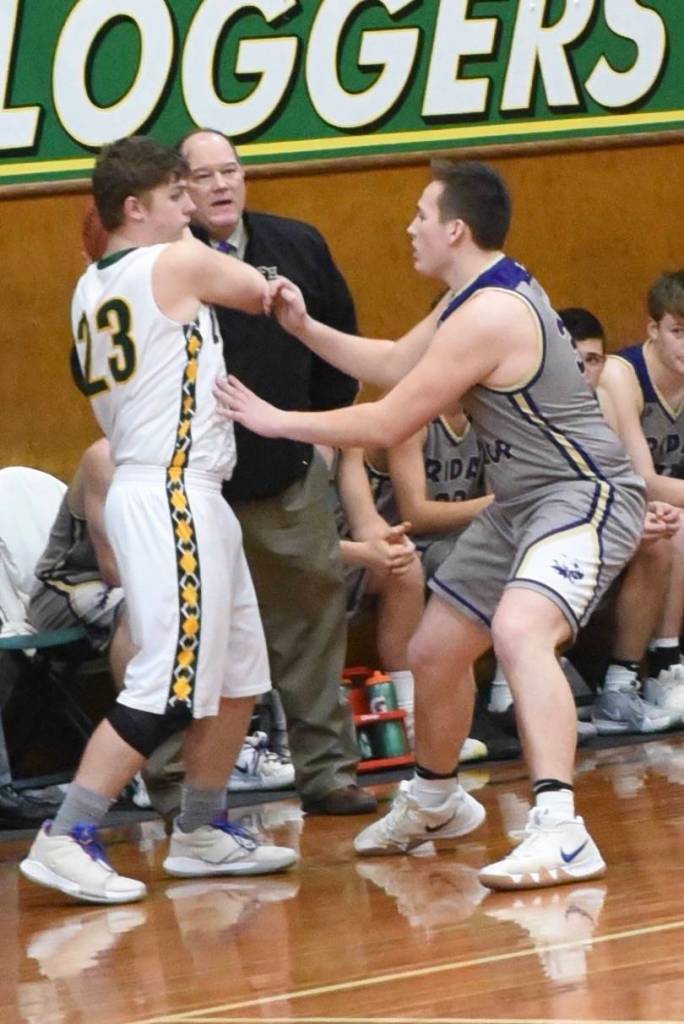 Gavin Mason applies defensive pressure. / John Stimpson photo