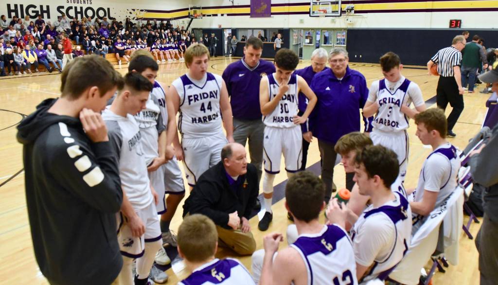 John Stimpson photo / Head Coach Rod Turnbull discusses strategy with the players during a time out.