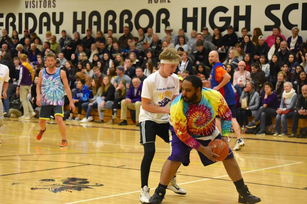 High school staff battle seniors on the court