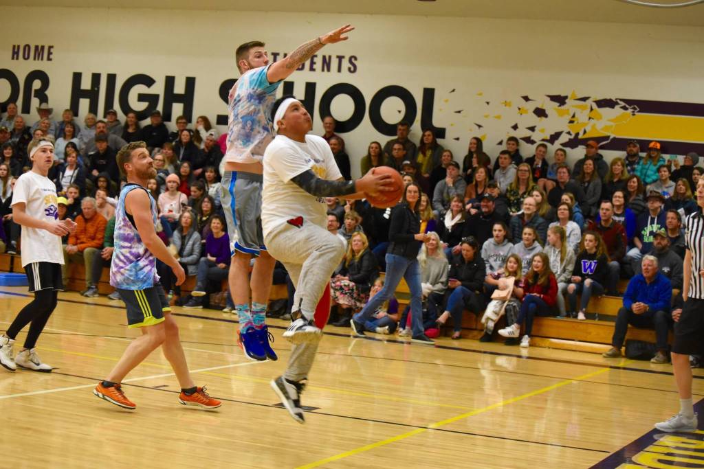 High school staff battle seniors on the court
