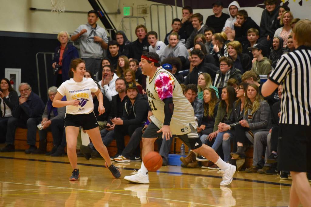High school staff battle seniors on the court