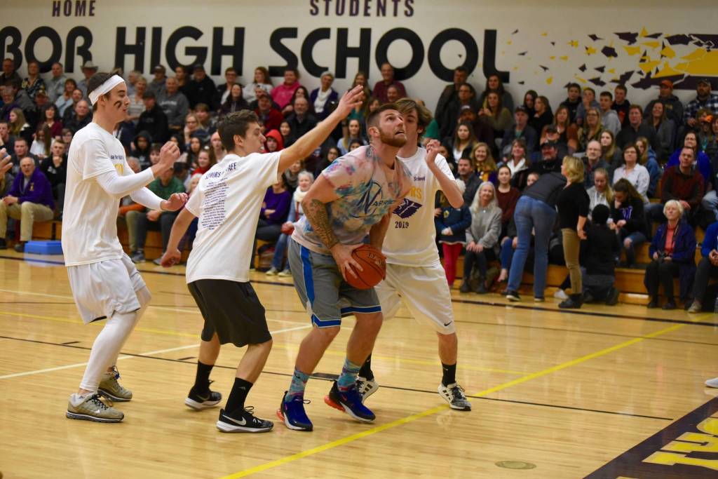 High school staff battle seniors on the court