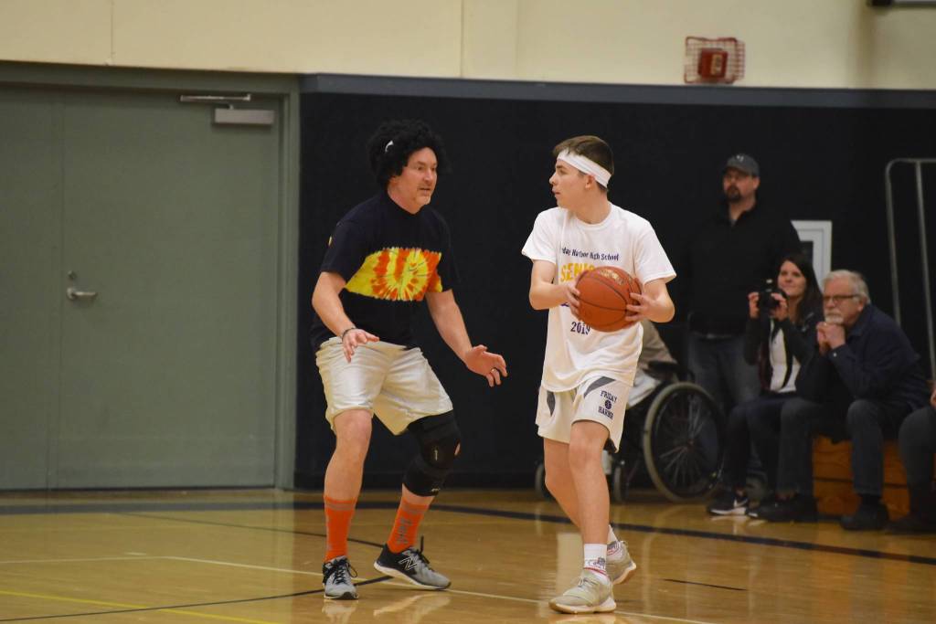 High school staff battle seniors on the court