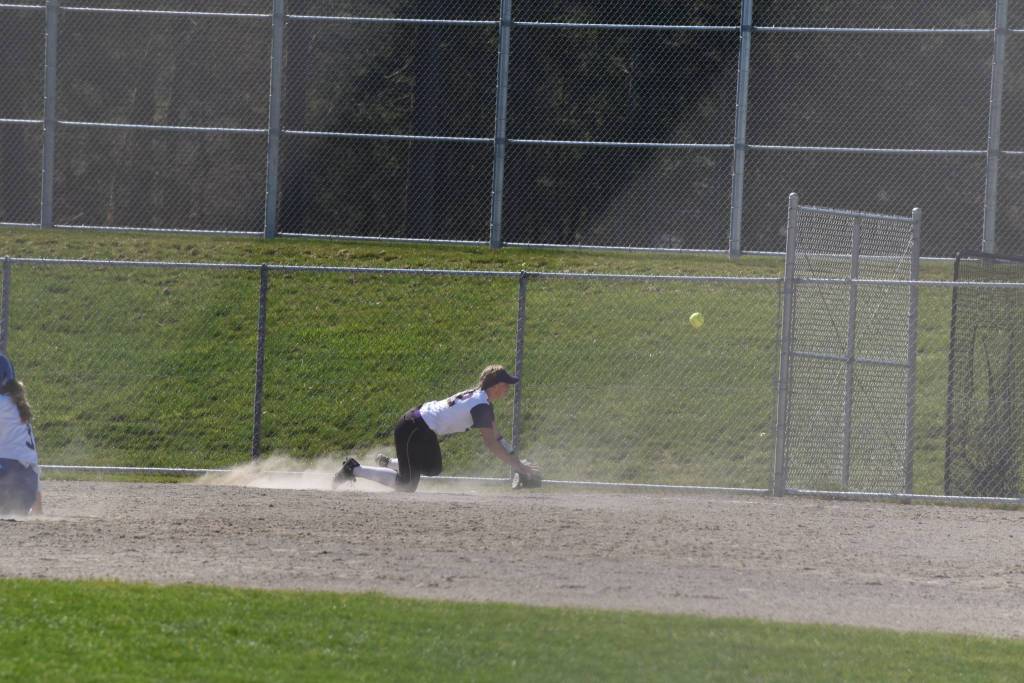 Staff photo/Tate Thomson                                Pitcher Grace Pauls throws ball to Jayna Ott on first.