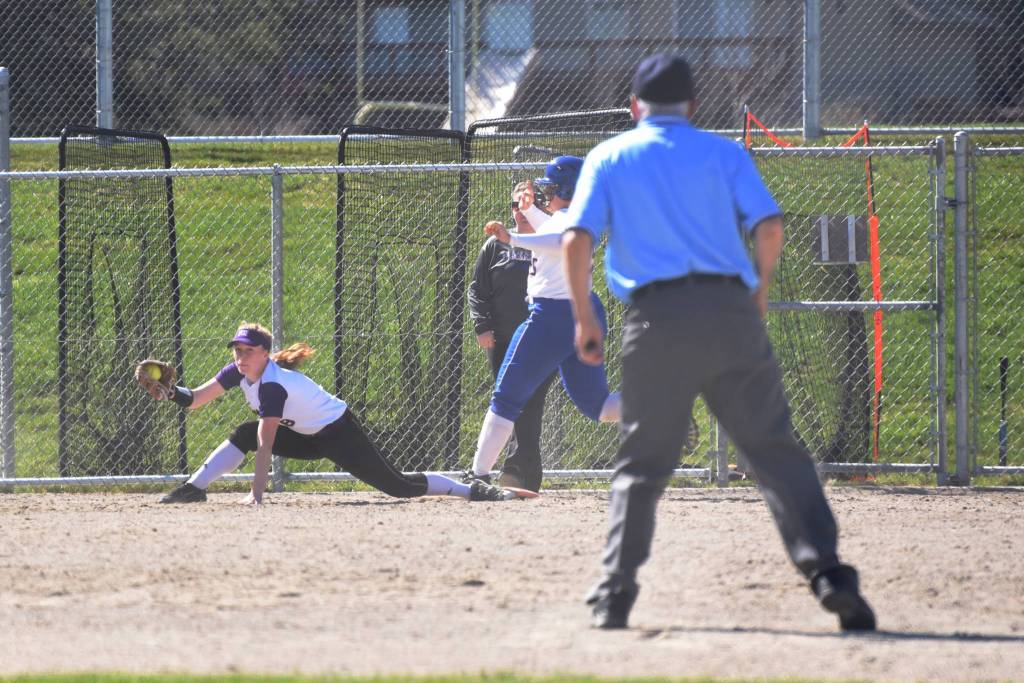 Staff photo/Tate Thomson                                Pitcher Grace Pauls throws ball to Jayna Ott on first.