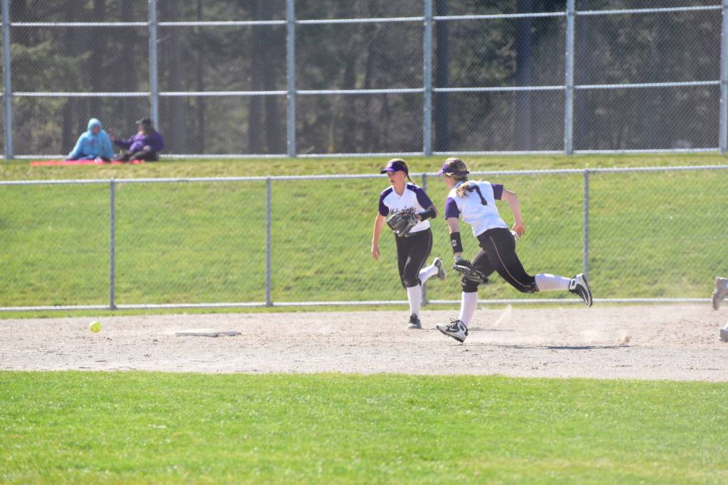 Staff photo/Tate Thomson                                Pitcher Grace Pauls throws ball to Jayna Ott on first.