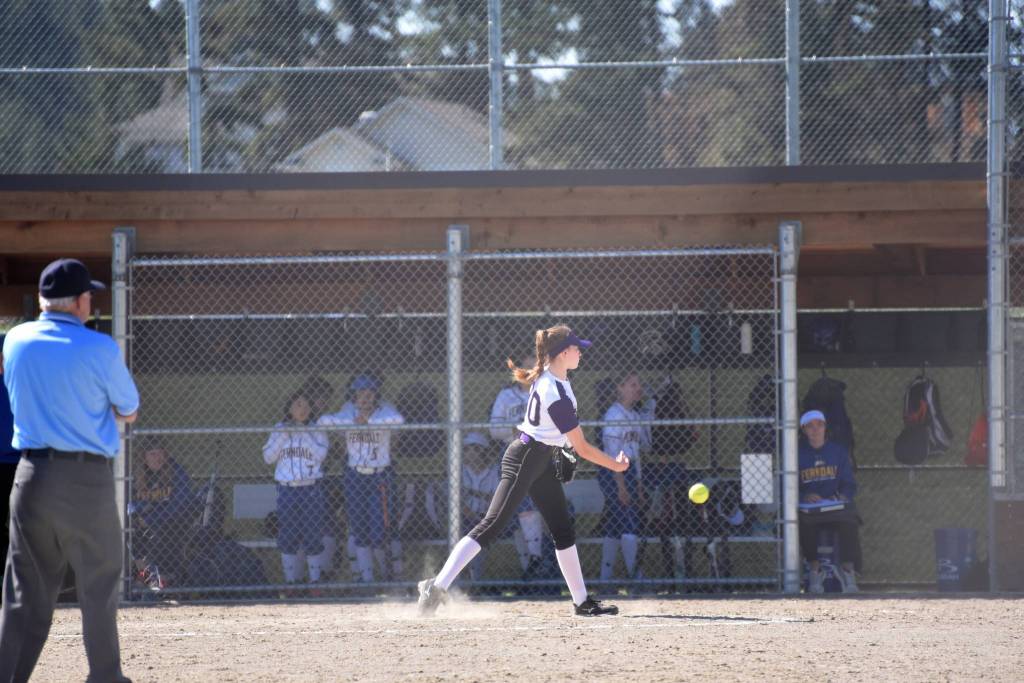 Staff photo/Tate Thomson                                Pitcher Grace Pauls throws ball to Jayna Ott on first.