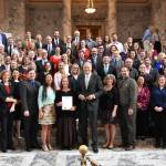 Supporters of the orca recovery bills stand for a photo after the governor signed the bills and read an orca proclamation. (Office of the Governor photo).